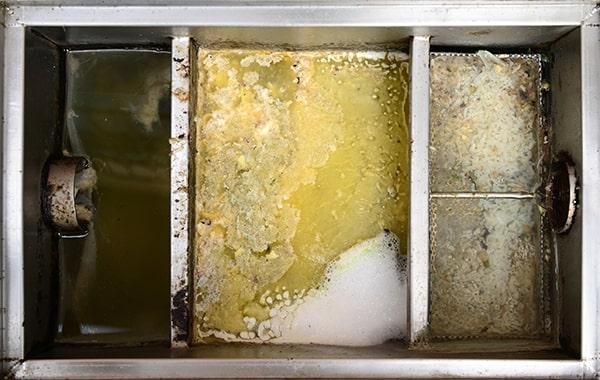 neglecting grease interceptor cleaning can cause clogs, backups, foul odors, and potential fines for non-compliance